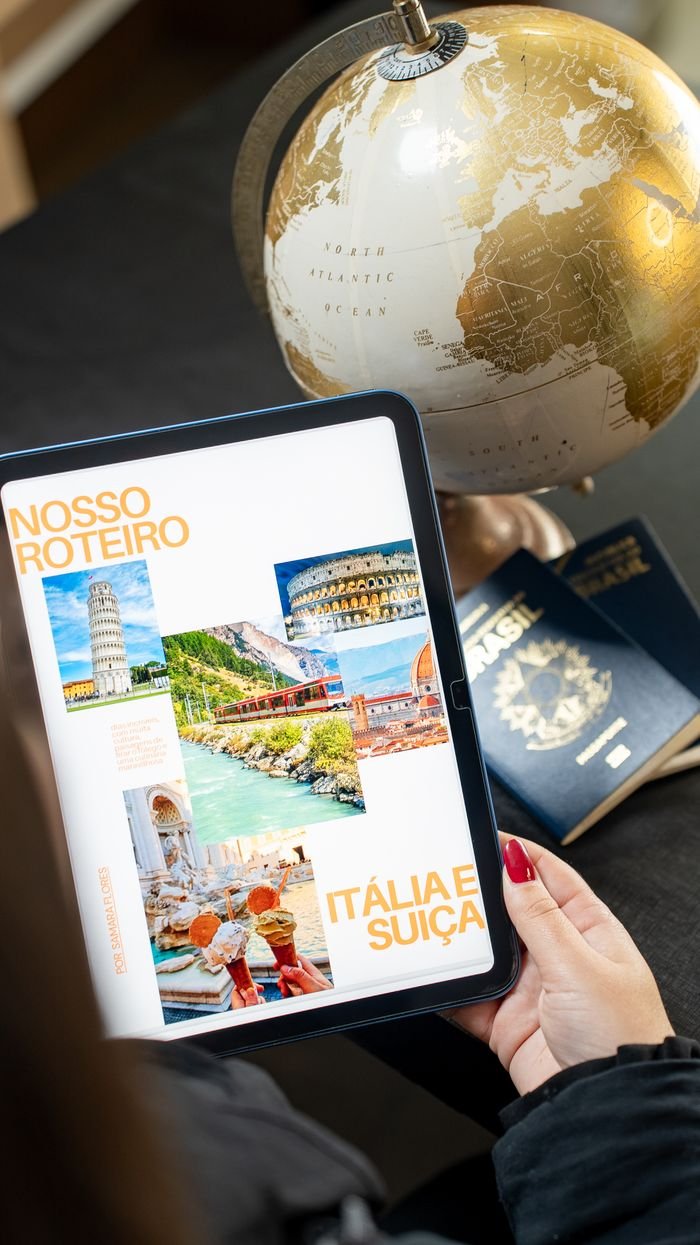Person planning a trip to Italy and Switzerland using a tablet and globe.travel agents for international travel